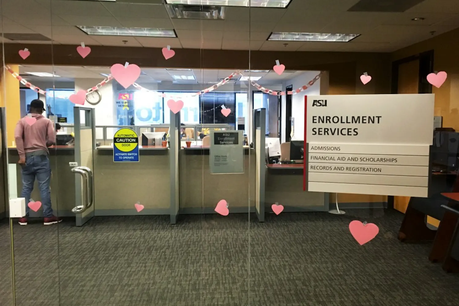 A student speaks with ASU enrollment services in the University Center on the Downtown Phoenix, Arizona campus on Monday, Feb. 13, 2017