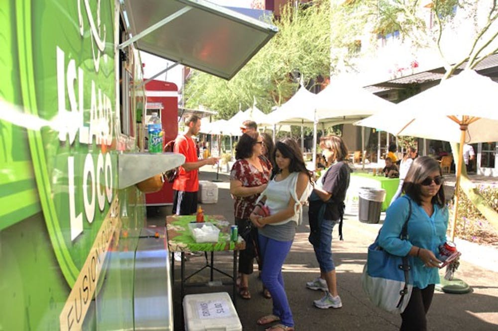 Hungry patrons wait for their Island Loco food during the Food Truck Fiesta on Tuesday afternoon at ASU's Downtown campus. (Photo by Tyler Griffin)