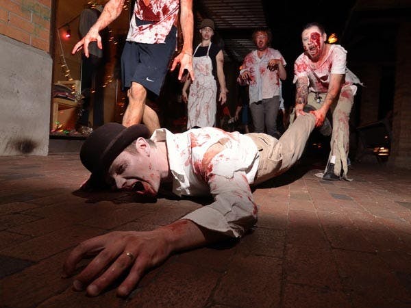 RUN FOR YOUR LIFE: Zombies walked Mill Avenue crawling and terrorizing pedestrians. Organizer Phil Alberton recruited zombies through Facebook for the third year to walk Mill Avenue Thursday night. (Photo by Aaron Lavinsky)