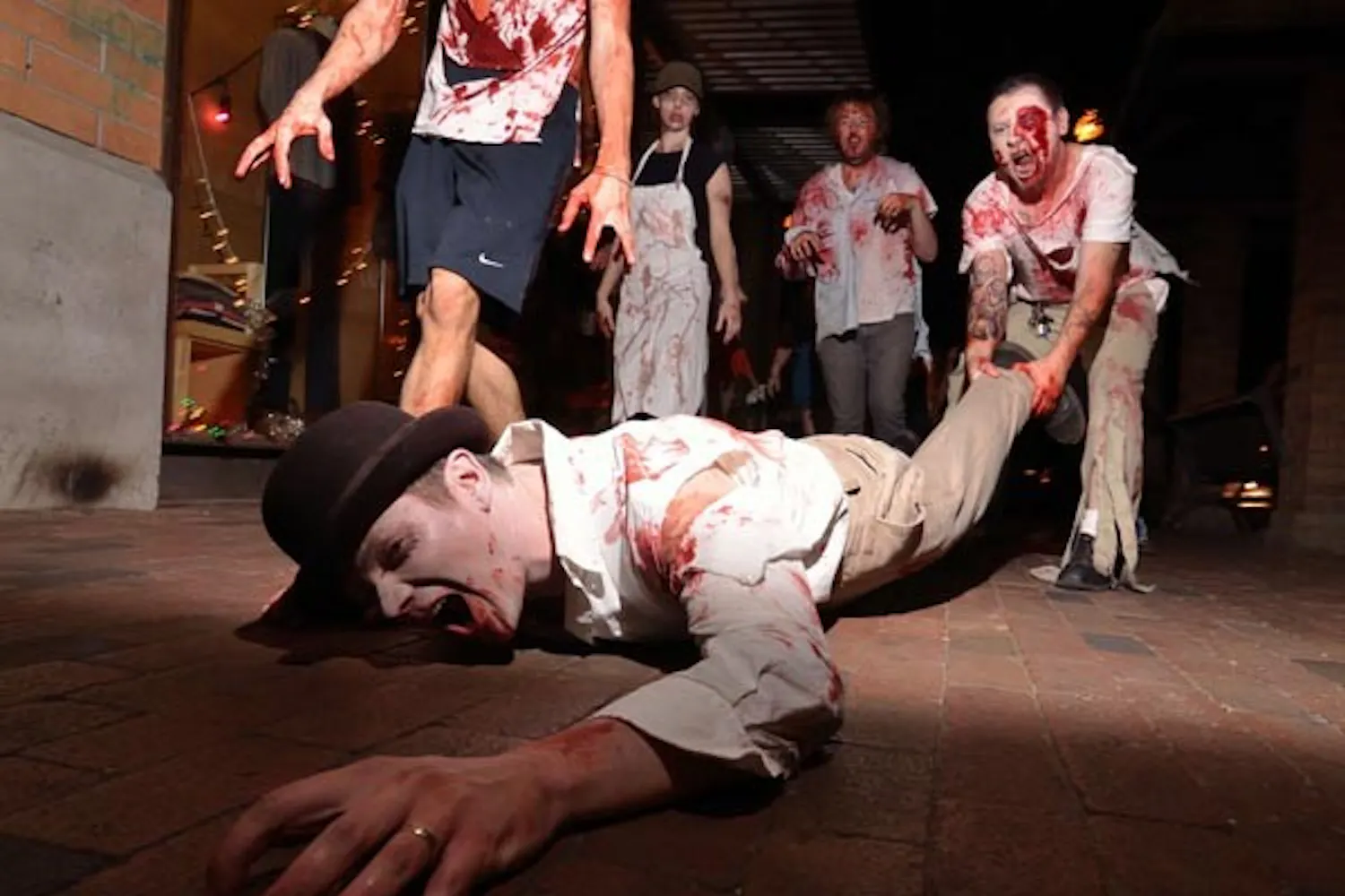 RUN FOR YOUR LIFE: Zombies walked Mill Avenue crawling and terrorizing pedestrians. Organizer Phil Alberton recruited zombies through Facebook for the third year to walk Mill Avenue Thursday night. (Photo by Aaron Lavinsky)