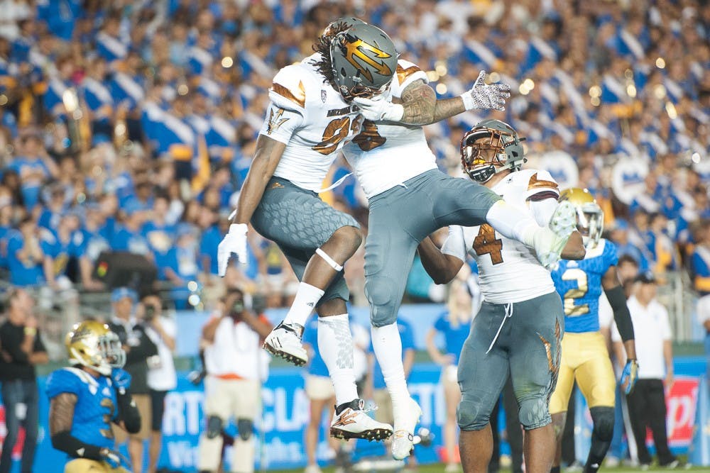 Redshirt senior wide receiver Gary Chambers (81) and senior wide receiver D.J. Foster (8) celebrate after a touchdown against UCLA on Saturday, Oct. 3, 2015, at Rose Bowl Stadium in Pasadena, Calif.