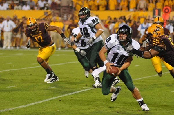 NO ESCAPE: Portland State junior quarterback Connor Kavanaugh tries to evade ASU senior defensive end Jamarr Robinson during Saturday's game. Kavanaugh finished 12-of-23 passing wit 146 yards and an interception in the loss. (Photo by Aaron Lavinksy)