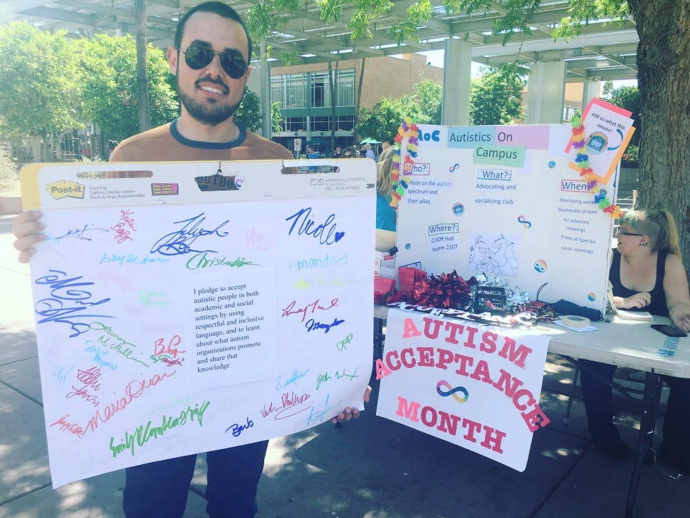 Zouheir 'Zak' Kabbara, Speech Inherit Sciences major, poses with a&nbsp;sign during Autism Acceptance Month at the ASU Tempe campus&nbsp;on&nbsp;April 12, 2016.