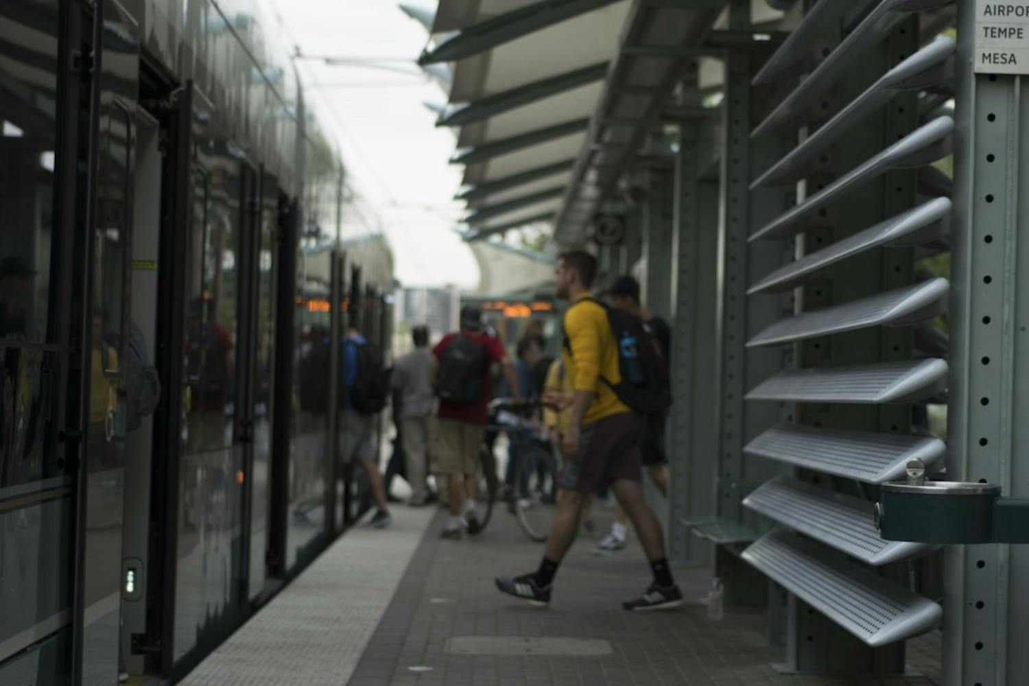 People shuffle on and off the light rail on Wednesday, Nov. 16, 2016, in downtown Phoenix, Arizona.