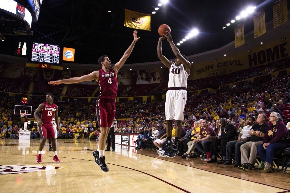 ASU senior forward Shaquielle McKissic shoots a 3-pointer against Stanford center Stefan Nastic at the ASU vs. Stanford basketball game at the Wells Fargo Arena on March 5, 2015. McKissic would drain the 3-pointer and had a team leading 23 points. (Daniel Kwon/The State Press)