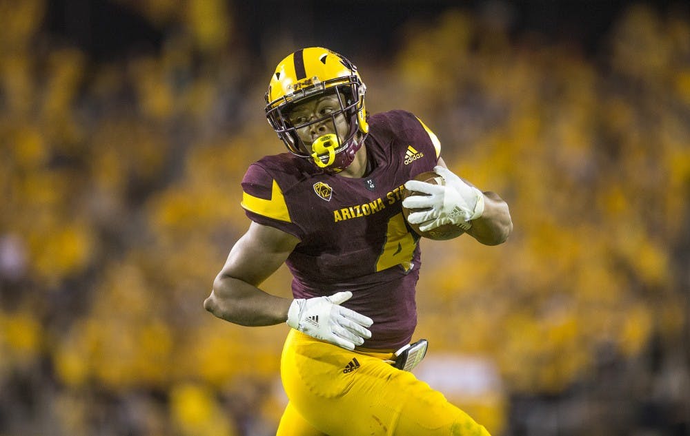 ASU Sun Devils running back Demario Richard (4) watches Cougar defenders as he runs towards the end zone during a game against WSU in Sun Devil Stadium, in Tempe, Arizona, on Saturday, Oct. 22, 2016.