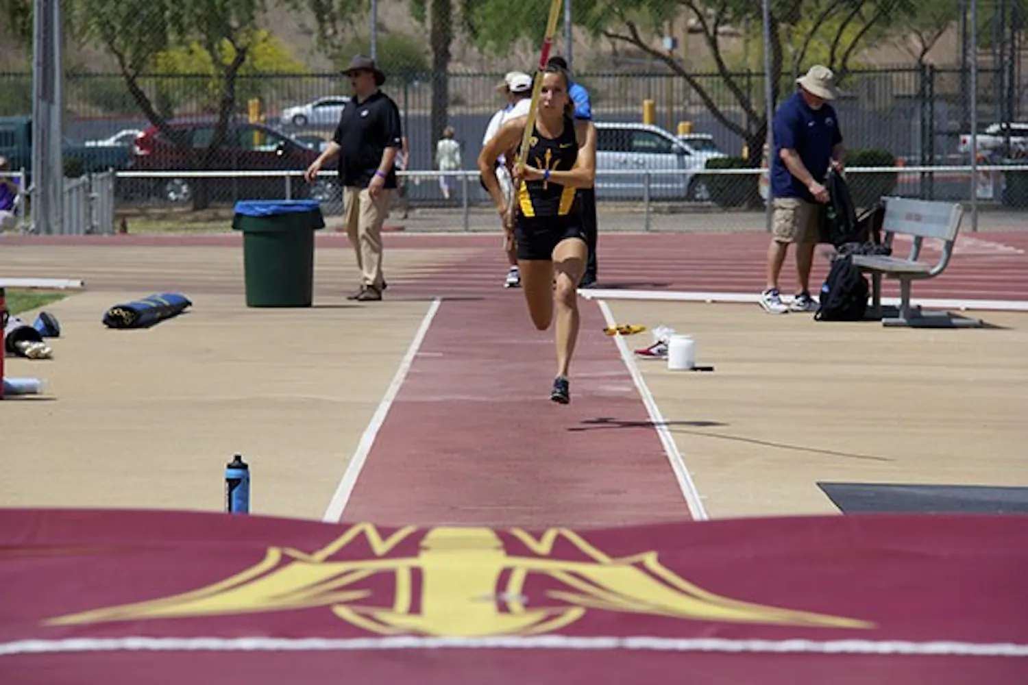 Sophomore pole vaulter Andrea Kemmerrer takes a running start before jumping over the bar during the Sun Angel Track Classic at Sun Angel Stadium on Saturday, April 12. (Photo by Becca Smouse)