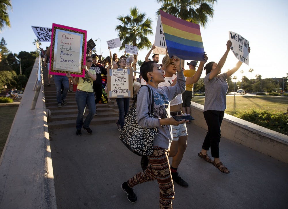 Protestors begin to march down the University Drive bridge during a protest of the 2016 presidential election results near the ASU Tempe campus on Friday, Nov. 11, 2016. 