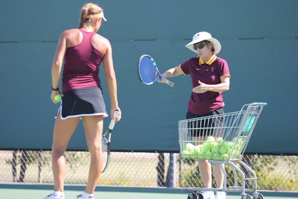 Tennis coach Sheila McInerney (right) offers advice to one of her players during a Sept. 19 practice. (Photo by Kyle Newman)