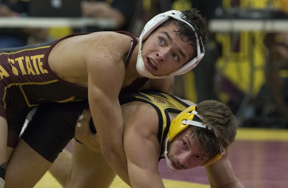 Redshirt freshman Mikel Perales, top, competes against freshman Josh Kramer during an intrasquad match on Friday, Oct. 30, 2015, at Ritches Wrestling Complex in Tempe. Perales defeated Kramer 2-1.