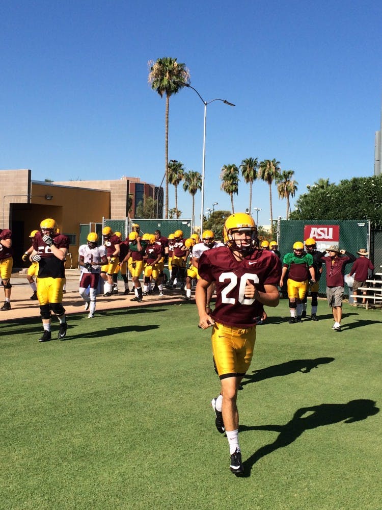 Players take the field for drills on Aug. 7. (Photo by Fabian Ardaya)