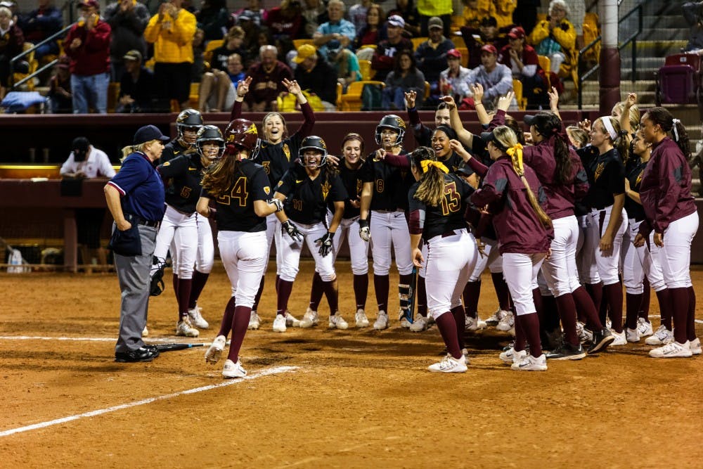 Teammates eagerly await ASU junior catcher Katee Aguirre after her 3-run homer vs. Indiana softball at Farrington Stadium on Feb. 7, 2015. Aguirre would have a monster game with a 3-run home run and a walk off single as the Sun Devils romped over the visiting Hoosiers 10-2.