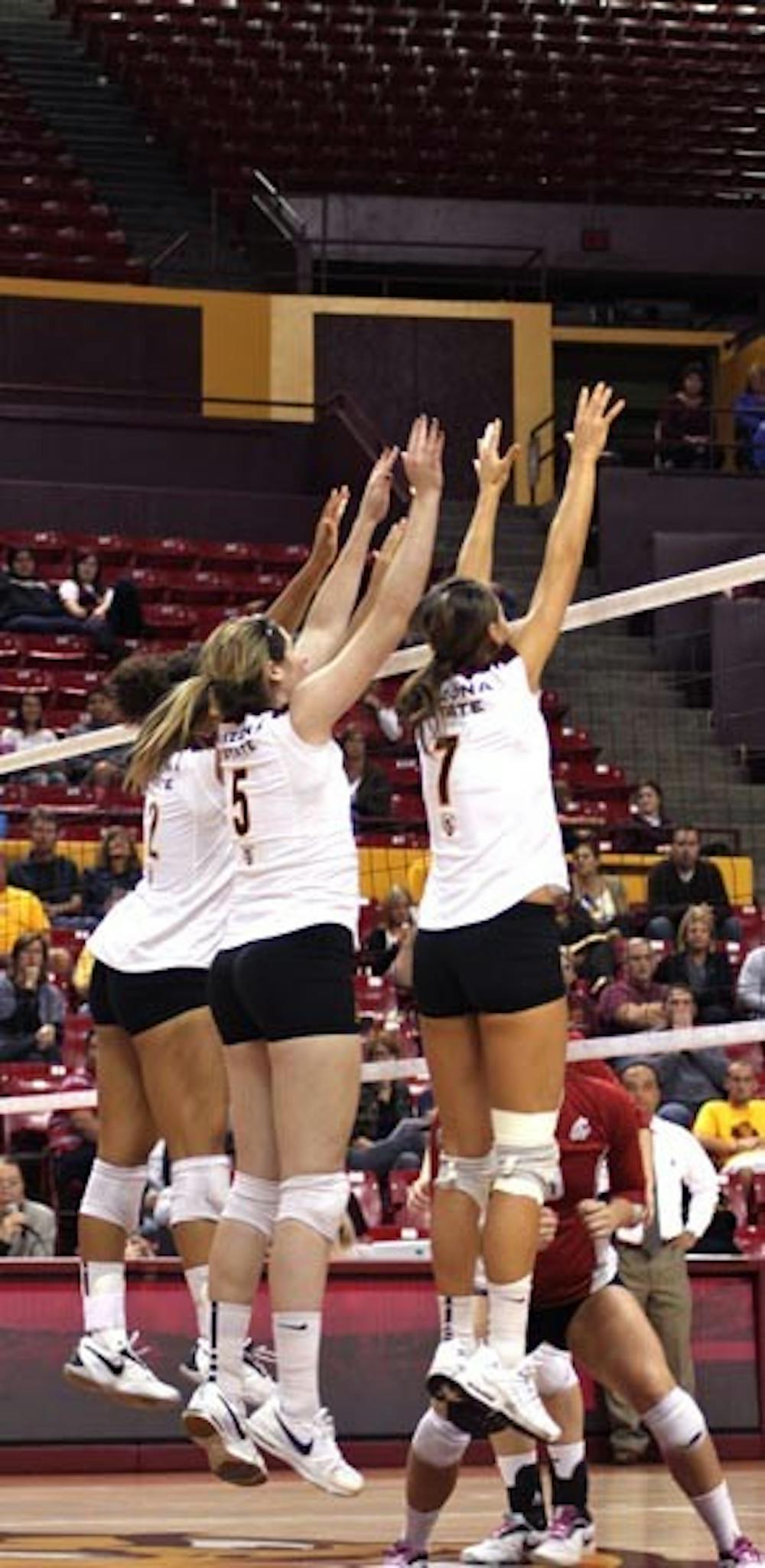 WALL BUILDING: ASU senior outside senior Sarah Reaves (left) goes up for a block with sophomore middle blocker Alexis Pinson (middle) and junior setter Cat Highmark during the Sun Devils 3-1 victory over Washington State on Saturday. It was the last home match of the season for ASU. (Photo by Rosie Gochnour)