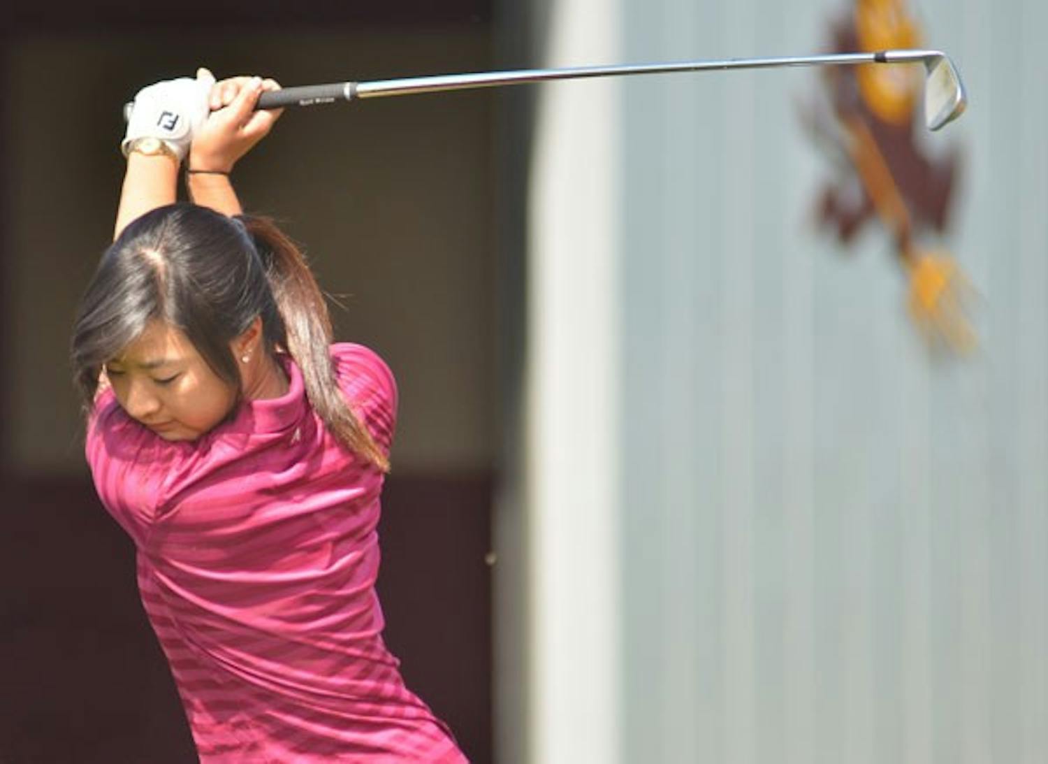 Home-course advantage: ASU freshman Justine Lee starts her downswing during a practice earlier this season. The Sun Devils are hosting the Pac-10 Championships this weekend and are hoping to make a move for the title. (Photo by Aaron Lavinsky)