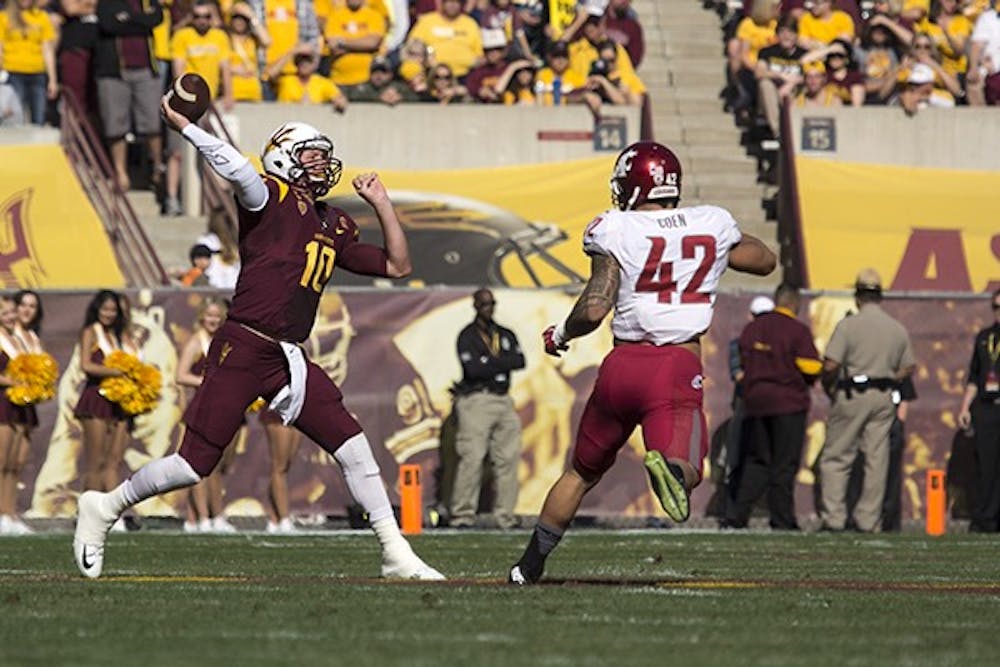 Redshirt senior quarterback Taylor Kelly throws a pass downfield during ASU's 52-31 win over Washington State at Sun Devil Stadium on Nov. 22, 2014. (Photo by Alexis Macklin)
