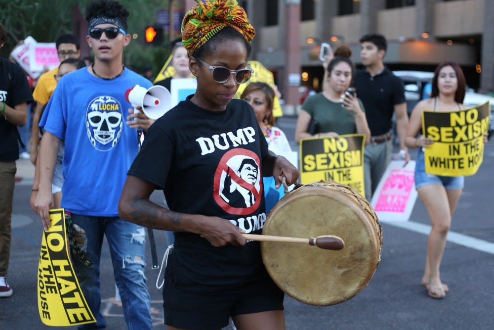 A protestor marches around downtown Phoenix during a Trump rally on Wednesday, Aug. 31, 2016. 