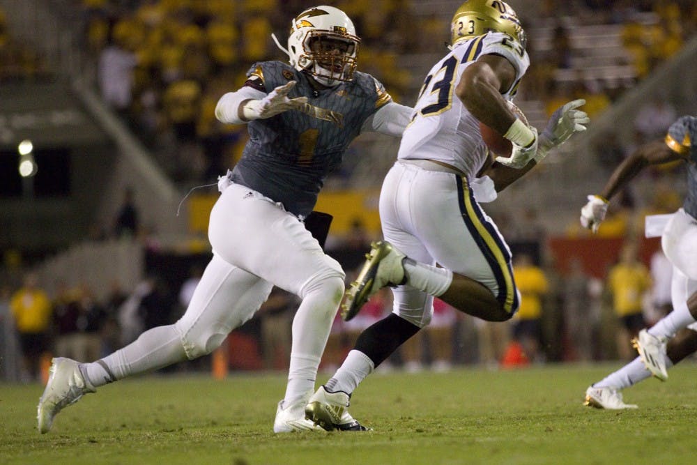 ASU sophomore linebacker JoJo Wicker (1) reaches out to complete a tackle on the UCLA running back in the second half of the 23-20 victory over the UCLA Bruins in Sun Devil Stadium in Tempe, Arizona, on Saturday, Oct. 8, 2016.