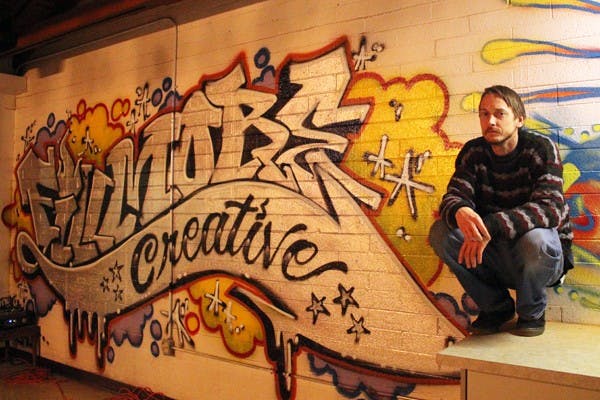 Joey "G." Grether poses in front of Fillmore Creative, a multifunctional production studio that brings together local artists with its many studios, including sewing, photography, tattoos and recording. (Photo by Jenn Allen)
