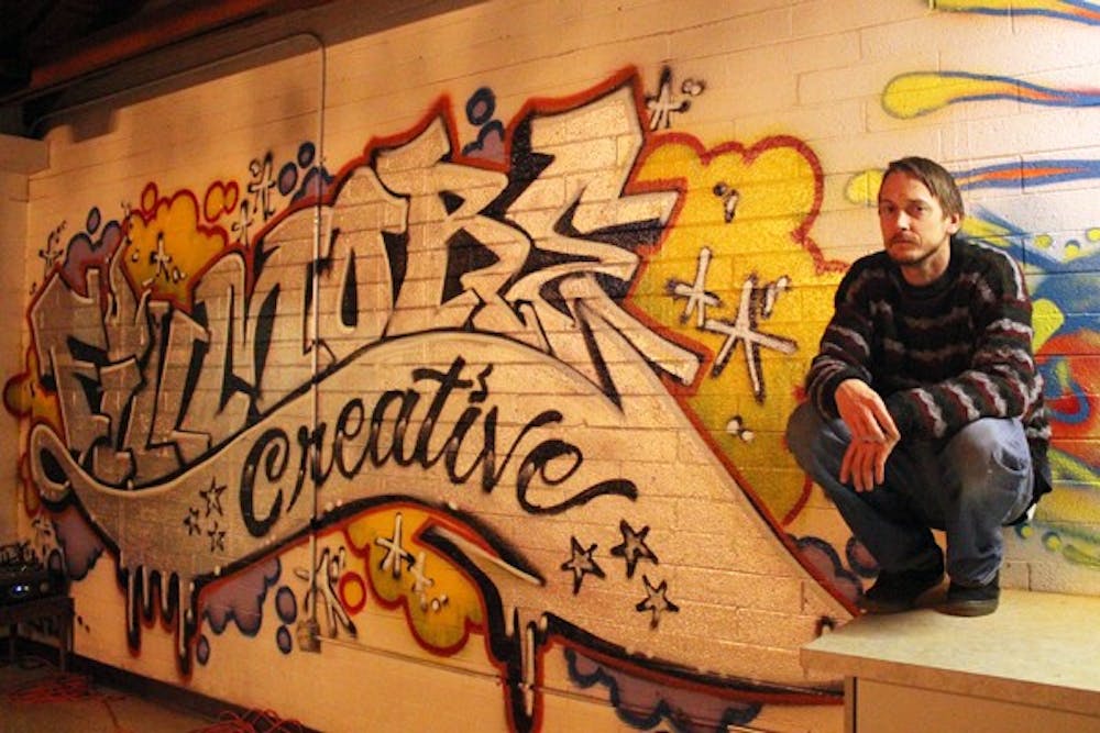 Joey "G." Grether poses in front of Fillmore Creative, a multifunctional production studio that brings together local artists with its many studios, including sewing, photography, tattoos and recording. (Photo by Jenn Allen)