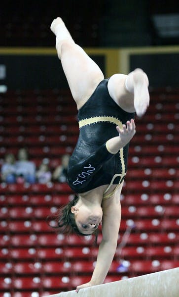 Natelle Gentile performs a beam routine in a meet against Illinois on Feb. 19. Gentile set her season-high score with a 9.825 against Washington. (Photo by Beth Easterbrook)