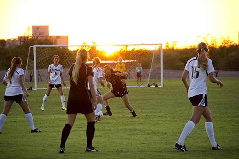 Junior midfielder Tommi Goodman dribbles the ball in a scrimmage against NAU on Aug. 15 at West campus. 