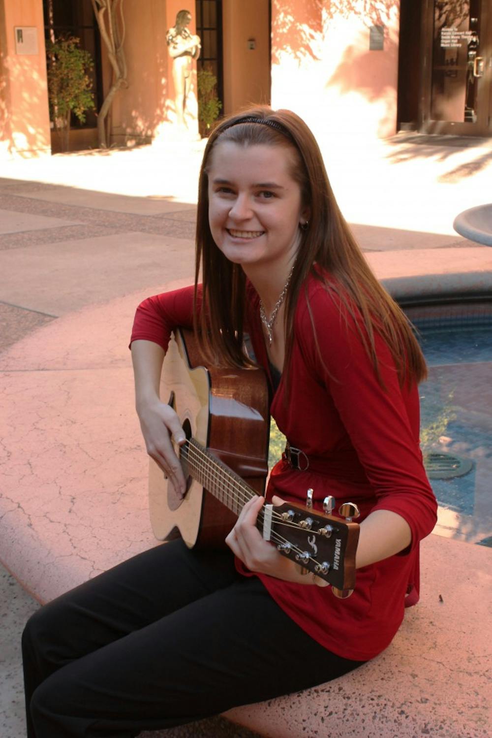 Shelbe Olson, music therapy major and sophomore, practices her guitar in the music building at ASU. Olson, along with other music therapy majors, are required to learn the basics of guitar and other musical instruments for their field of study. (Photo by Laura Davis)