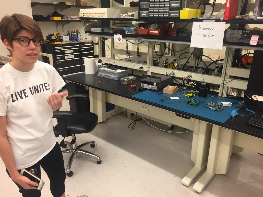 Sarah Rogers points to equipment that is&nbsp;used to test software for the CubeSat in a lab on ASU's Tempe campus&nbsp;on March 3, 2017.