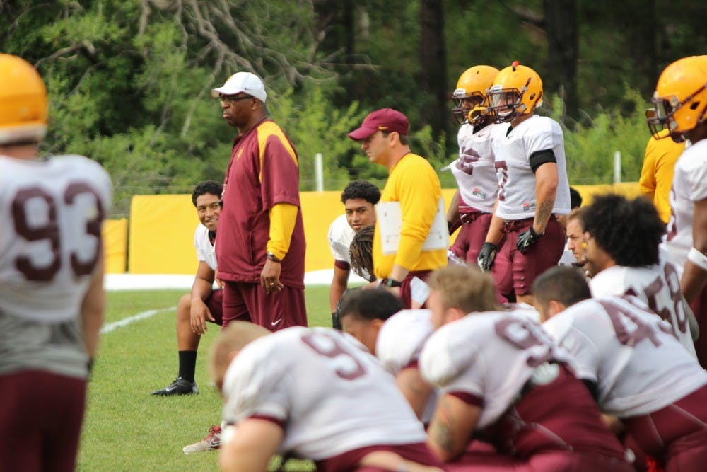 Freshmen linebackers Alani and Villiami Latu kneel next to each other during a walkthrough practice at Camp Tontozona. The twins have been inseparable throughout their childhood, and remain close as they begin the 2013 season with ASU.  (Photo by Dominic Valente)