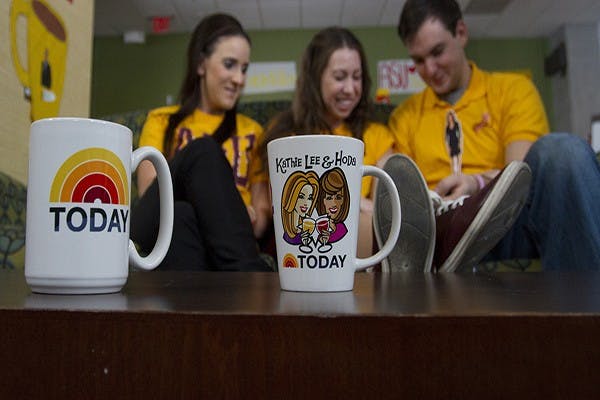 Nursing sophomore Allison Shuman, journalism sophomore Kate Sitter, exercise and wellness sophomore Karl Cormack watch videos as they wait for the live taping of the Today Show on the Downtown campus on Wednesday, Oct. 23, 2013. The national morning show came to ASU after seeing a viral video of super fans living in the Taylor Place residence hall.  (Photo by Caitlin Cruz)