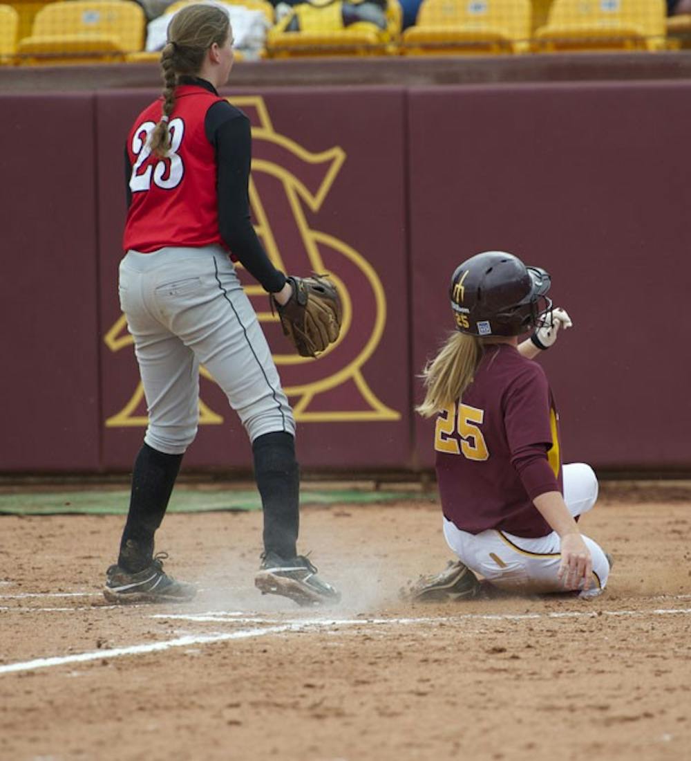 SHE'S SAFE: ASU junior catcher Lacy Goodman slides across home plate in the Sun Devils’ win against Rutgers last month. The Sun Devils swept Cal Poly over the weekend. (Photo by Michael Arellano)
