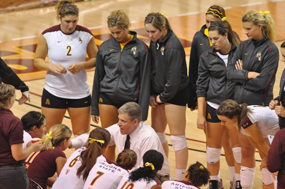 COACH’S CIRCLE: Volleyball coach Jason Watson (center) addresses his players during a game last October. Watson missed a portion of last weekend’s Sheraton Classic due to health issues, but now has fully returned to his coaching duties. (Photo by Aaron Lavinsky)