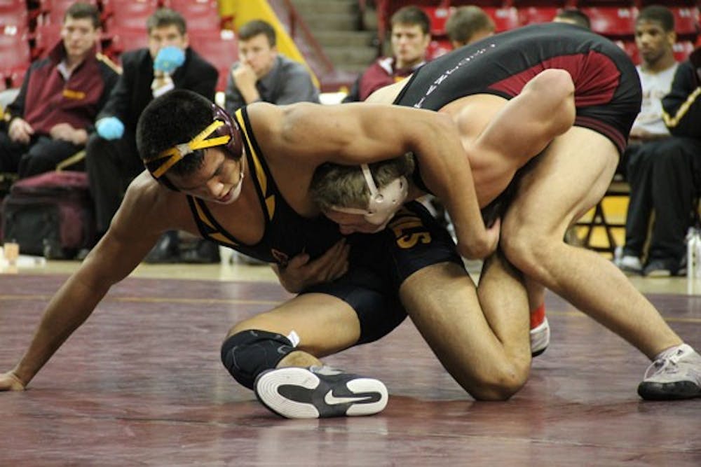 Former ASU wrestler Eric Starks tries to escape a take down from Stanford senior Nick Amuchastegui on Feb. 2, 2012. ASU looks to gain some momentum for the Pac-12 tournament against Oregon State this weekend. (Photo by Diana Lustig)