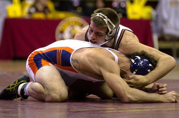 SHUT DOWN: Junior Jake Meredith works over Cal Poly junior Kelan Bragg during the Sun Devils’ 40-11 loss on Jan. 30. ASU dropped another two matches against No. 14 Nebraska and No. 15 Iowa State over the weekend. (Photo by Aaron Lavinsky)