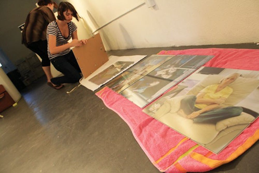 Photography major, Briana Noonan, began set up of her "Split" exhibit Friday at the Step Gallery, which will open on Monday. (Photo by Jessie Wardarski)