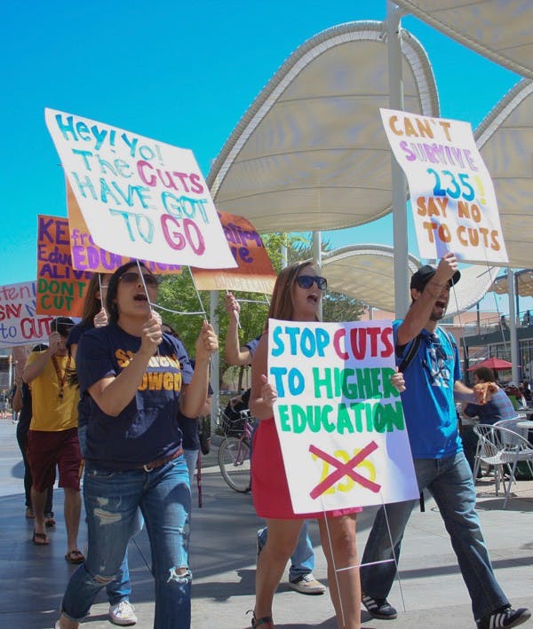 FIGHTING CUTS: Students rally against statewide education budget cuts outside of the Memorial Union on the Tempe campus Wednesday morning. A recently passed senate proposal could lead to a $235 million cut from the state university system, $100 million of which could affect ASU. (Photo by Lisa Bartoli)