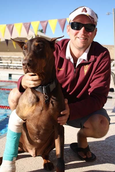 ASU swim coach Dan Kesler and his dog BA reunited after BA had been missing for seven years. (Photo by Jessie Wardarski)