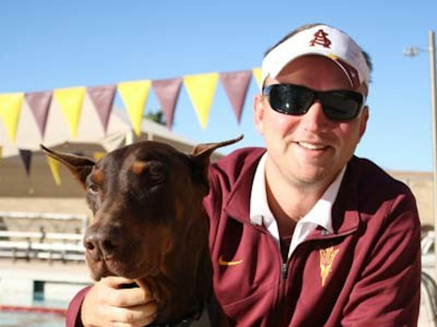 ASU swim coach Dan Kesler and his dog BA reunited after BA had been missing for seven years. (Photo by Jessie Wardarski)