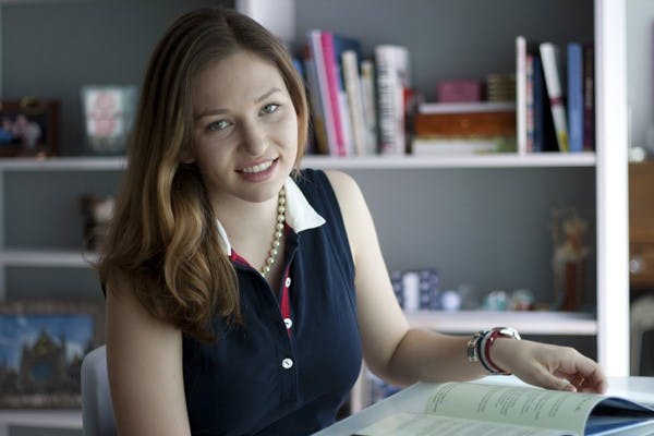 Political Science junior, Annica Benning, sits at her desk in her home with her book in hand. Benning wrote a book on Native American art and culture based on her personal research. (Photo by Perla Farias)