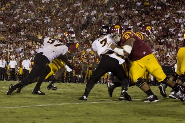 Redshirt sophomore defensive lineman Edmond Boateng tackles a USC player on Oct. 4, 2014 in Los Angeles. ASU won against USC 38-34. (Photo by Alexis Macklin)