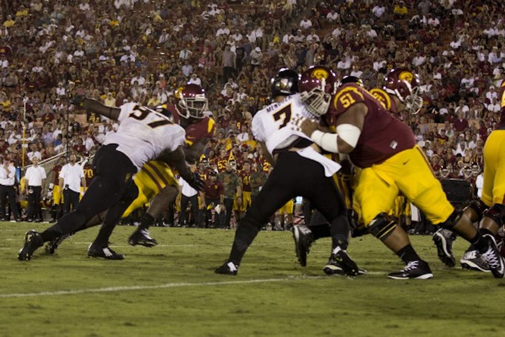 Redshirt sophomore defensive lineman Edmond Boateng tackles a USC player on Oct. 4, 2014 in Los Angeles. ASU won against USC 38-34. (Photo by Alexis Macklin)