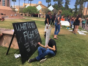 Students gather near Hayden Lawn on ASU's Tempe Campus in protest&nbsp;of Trump administration policies&nbsp;on Thursday, April 13, 2017.