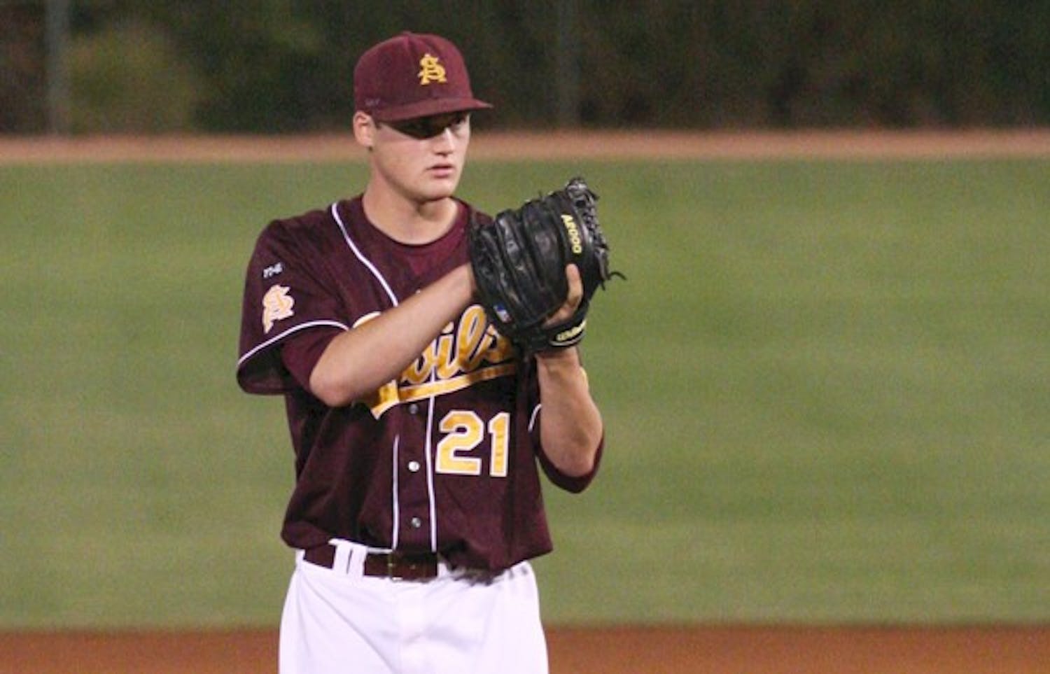 Another Series Win: ASU junior pitcher Kramer Champlin takes pitch signals during the Sun Devils game against Washington State on April 16. Champlin took the loss after giving up five runs, three earned, in ASU’s second game against Stanford over the weekend. (Photo by Lisa Bartoli)