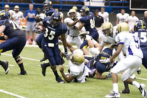 HOMECOMING: Northern Arizona freshman running back and Chandler Hamilton High School graduate Zach Bauman defenders in his college debut against Western New Mexico last week. (Photo Courtesy of NAU)