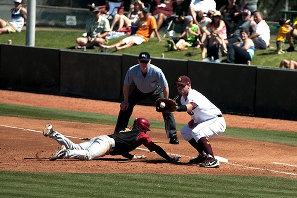 Junior catcher Nate Causey stops a USC player from stealing second base at a home game on April 6, 2014. (Photo by Mario Mendez)