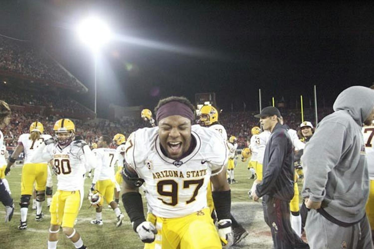TERRITORIAL TRIUMPH: Freshman defensive end Junior Onyeali reacts to ASU's 30-29 Territorial Cup win over UA on Thursday night. The Sun Devils won the game in double overtime after a blocked extra point attempt. (Photo by Scott Stuk)
