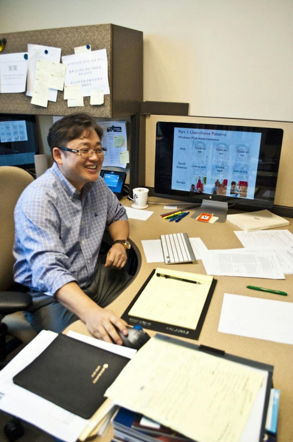 Gail-Joon Ann sits at his desk and explains his picture password project, a project he believes can make networks around ASU and the country safer. (photo by Katie Dunphy)