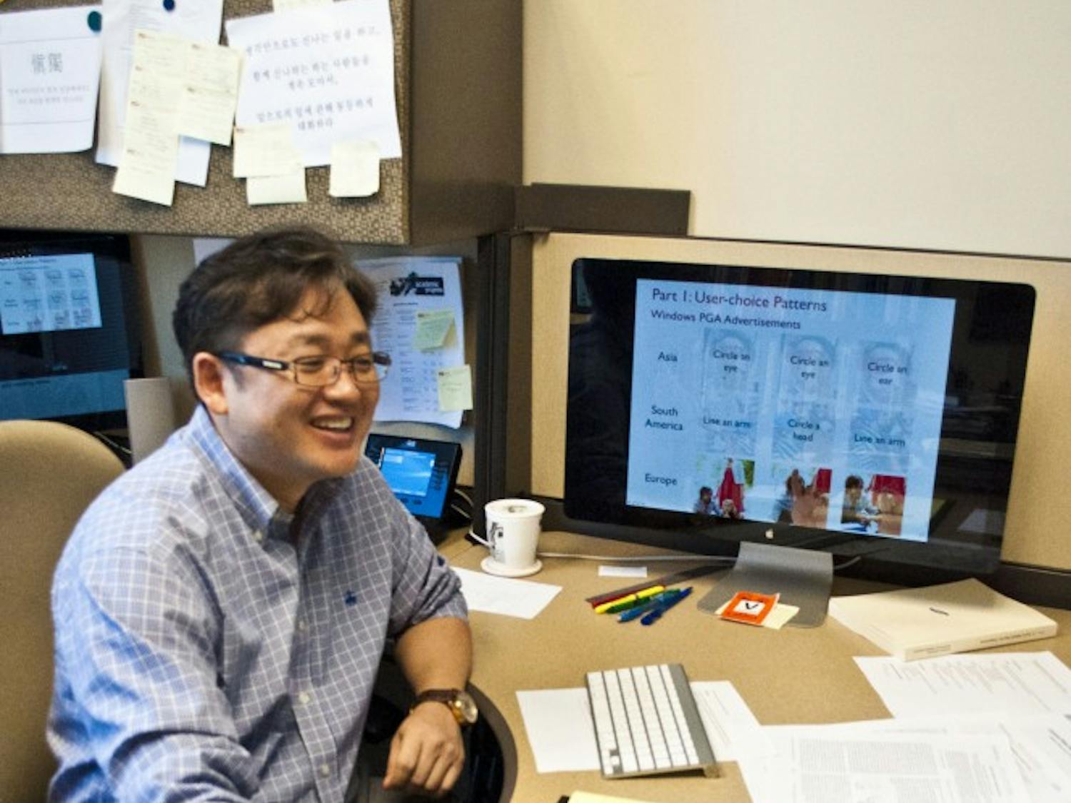 Gail-Joon Ann sits at his desk and explains his picture password project, a project he believes can make networks around ASU and the country safer. (photo by Katie Dunphy)