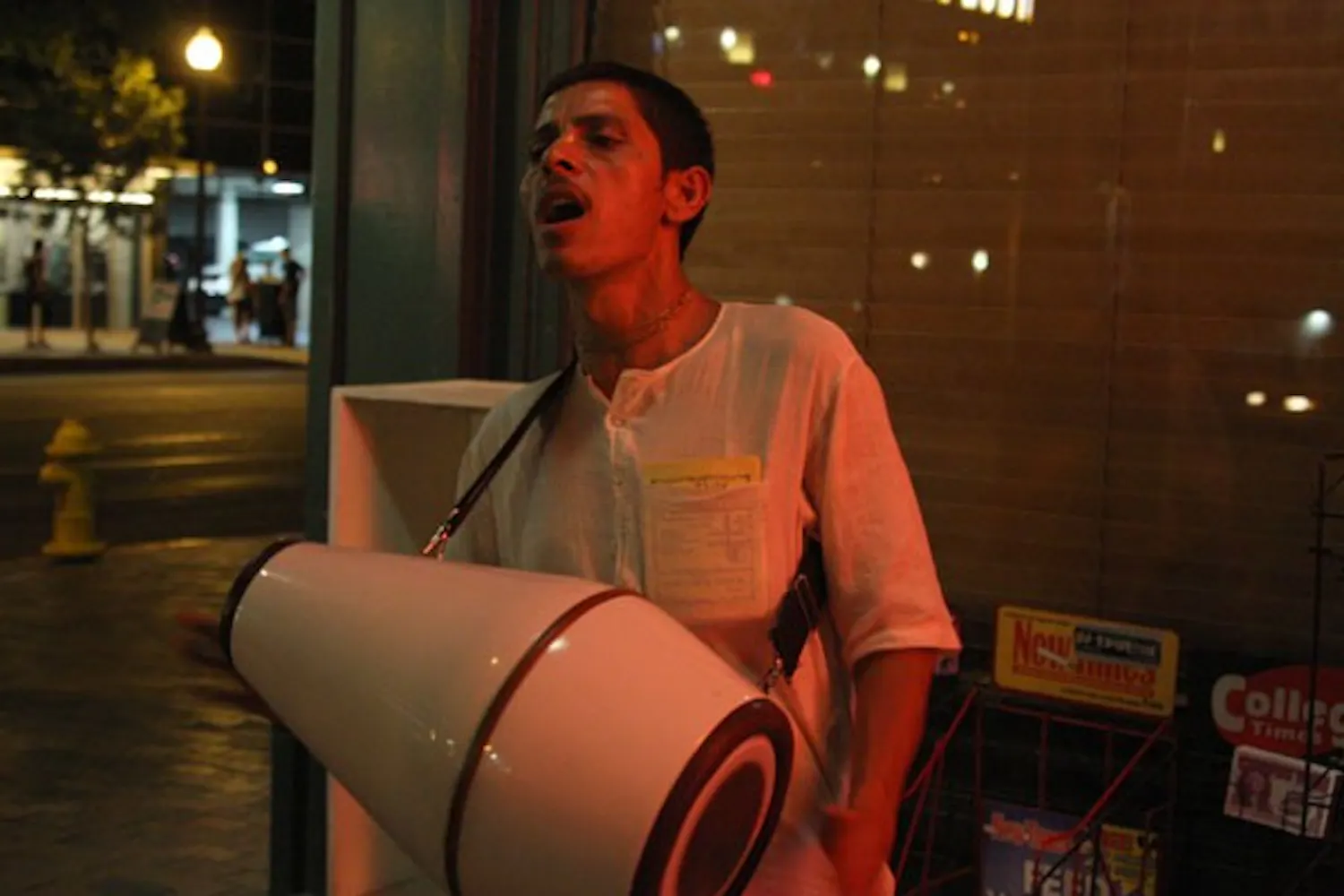 SERWAA ADU-TUTU | THE STATE PRESS
HARE KRISHNA: Janardan Das bangs his drum and chants on Mill Avenue Friday night, inviting passersby to visit the Hare Krishna Temple in Chandler.
