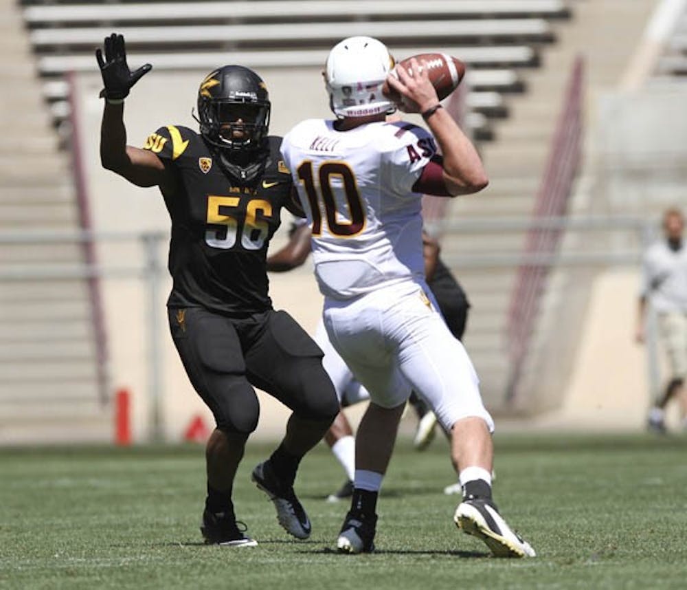 Redshirt junior linebacker Grandville Taylor (56) rushes after redshirt sophomore quarterback Taylor Kelly during ASU’s Spring Game last April. Taylor and fellow redshirt junior linebacker Brandon Johnson both received athletic scholarships, coach Todd Graham announced Tuesday. (Photo by Sam Rosenbaum) 
