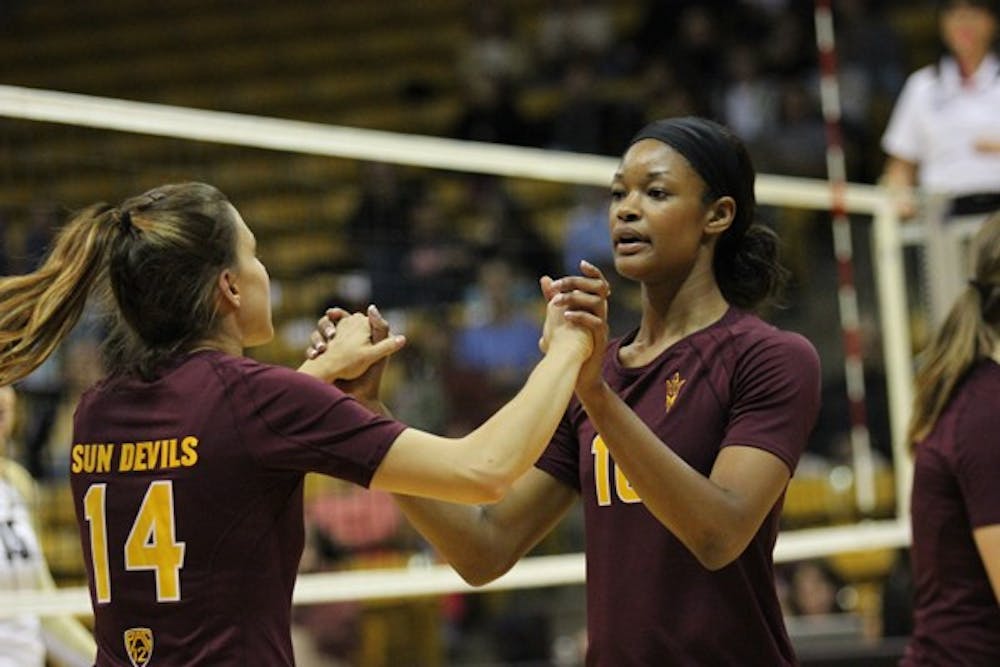 Senior outside hitter Erica Wilson (10) celebrates a point with junior libero Caitlyn Francis (14) after a point in the loss to Colorado on Oct. 12. (Photo by Kyle Newman)